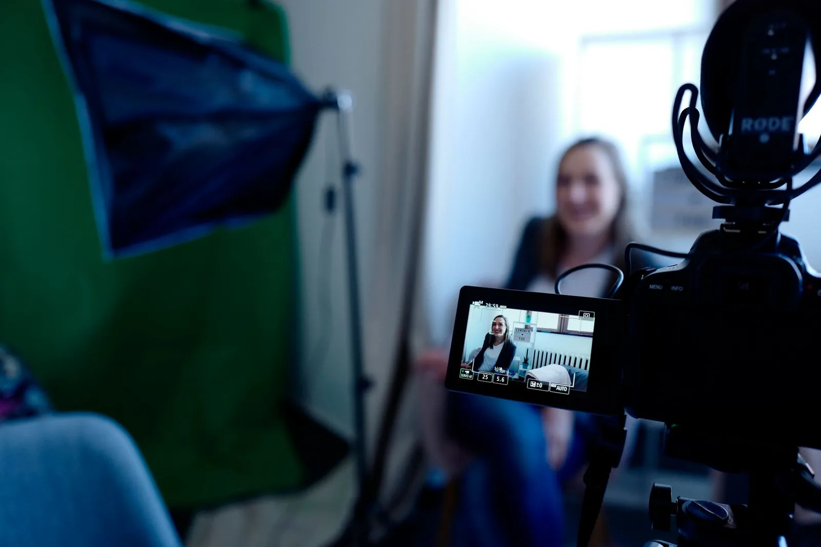 Creator being filmed in a professional studio setup with camera and lighting